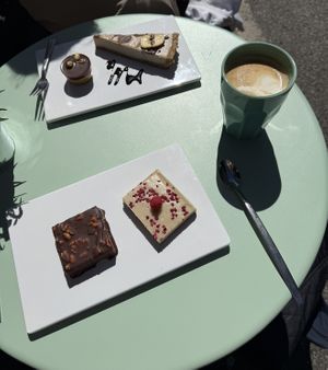 Outside seatings and peanut chocolate cake and banana chocolate cake and cappuccino with oat milk   at gesund & süß in Cologne