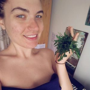 Laura and some fresh rocket from the garden :) at The Vegan Anarchist Communal Kitchen in Esztergom