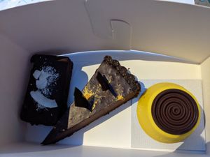 Coconut cherry chocolate cake (left), chocolate ganache, and lemon cake (right) at Aurora Sweets in Korcula