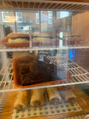Cakes and sausage rolls at Monstera Canteen in Luton