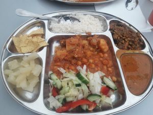 Buffet plate, rice, channa masala, baingan masala, salad, ananas, aloo curry, some dahl thing at Aahaar Indian Cuisine in Antwerpen