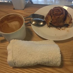 Sticky bun and oat milk cappuccino  at Kind Cafe in Vancouver