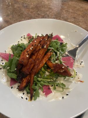 Seasonal gojuchang carrot arugula salad with daikon and a creamy base  at Craft Roots  in Morgan Hill