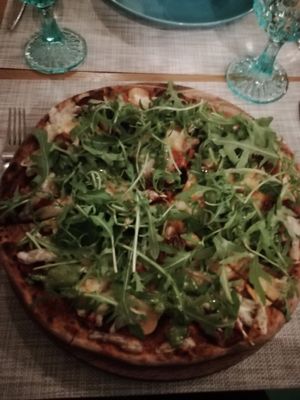 Pizza with vegan cheese, vegan sausage and seitan with basil pesto and rocket at Fenkhel Fennel in Kyiv