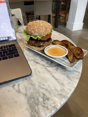 Burger with house habanero hot sauce and rosemary potato wedges   at Lamara Coffee and Kitchen in New Orleans