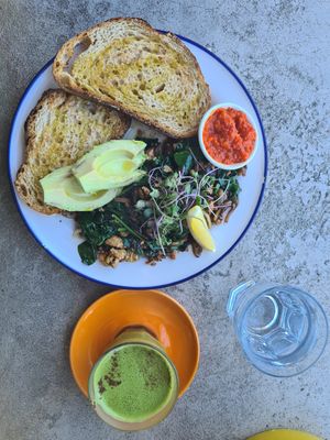 Tofu & Mushroom Scramble (+avo and relish) and macha latte. Yum! at Harvest Cafe in Daylesford