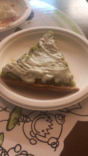 Broccoli quiche covered in garlic mayo type sauce that we added. at Las Niñas Veganas in Cadiz