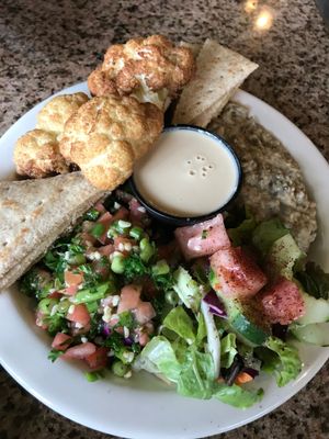 Sampler platter with fried cauliflower, babaganoush, tabouli, and fettoush, served with pita and tahini sauce. at Mooney's Mediterranean Cafe in Winston-salem