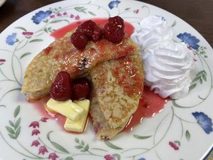 Half a stack of American-style pancakes with cream and fruit at Hank's Deli & Shop in Ipswich