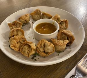 Deep-fried dumplings with tofu, coriander, chilli, hazelnuts, soy sauce, agave syrup and lime juice served with spicy mango sauce  at Pierogarnia Mandu Centrum in Gdansk