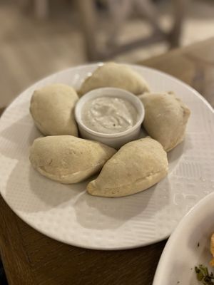 Dumpling from furnance on a fluffy yeast dough/
 Meat a'la beef, cheddar, pickled cucumber, red onion, mayonnaise and ketchup served with vegan mayonnaise  at Pierogarnia Mandu Centrum in Gdansk