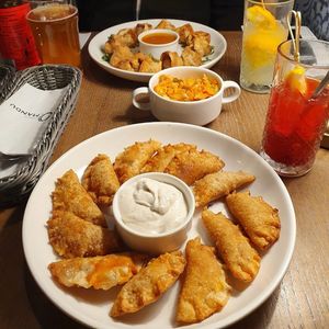 Two sets of vegan fried dumplings (tofu and paprika with vegan mayo, Thai dumplings with spicy mango sauce) and kimchi at Pierogarnia Mandu Centrum in Gdansk