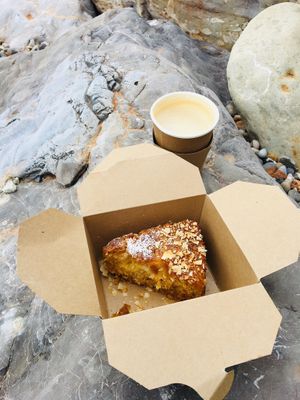 Yummy takeaway vegan coconut and lime cake and coffee, on stones throwaway beach! at The Hideaway in Seaton