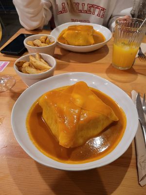 francesinha with potato wedges at Kind Kitchen in Porto