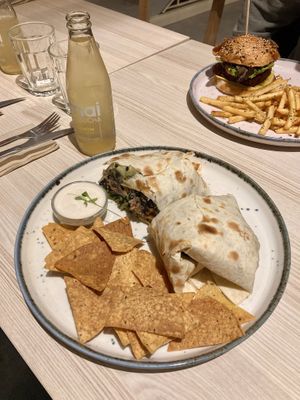 Supreme burrito, seitan burger on the backround  at Kind Kitchen in Porto