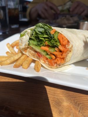 Trailhead wrap with hummus, cucumber, avocado and carrots— took the picture after eating the first half 😂 got guacamole on the side and fries.   at Trapper Grill in Moran
