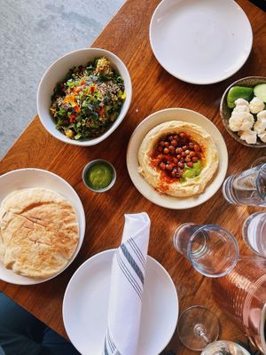 Warm pita bread, Avocado crispy rice, hummus, veggie plate, side of schug. at Butcher & Bee in Nashville