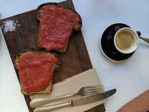 Cortado with oat milk and pan con tomate with hearty homemade bread (€2,50)! at La Casa Encendida in Madrid