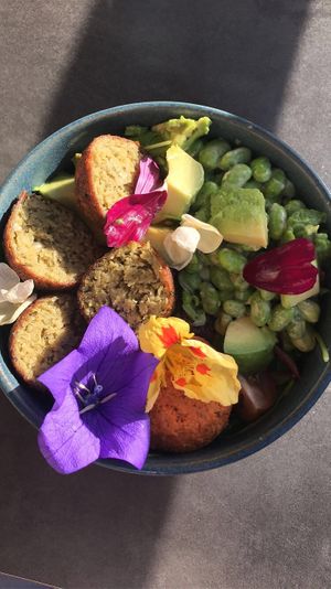 Vegan Budha Bowl with falafel, avocado, lentils, edamame beans, humus lettuce and edible flowers. at Bom in Bouillon