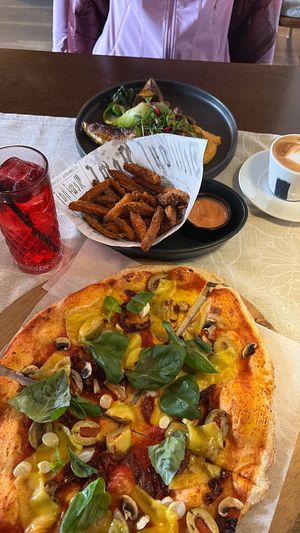 The vegetarian pizza with vegan cheese , eggplant dish in background . Ignore middle app it wasn’t mine at Castello Pizzeria in Kuressaare