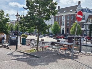Outdoor seating near the water at De Volkslust in Haarlem