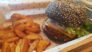 Flower burger : black bun (vegetable charcoal), jeans and seitan Patty, lettuce, soybean sprouts, tomato confit, Flower cheddar, magik sauce : Awesome! at Flower Burger in Marseille