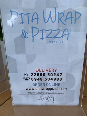 Restaurant sign  at Pita Wrap & Pizza in Mykonos
