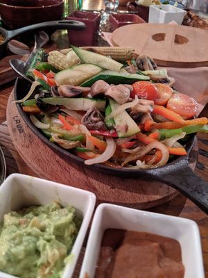 Fajitas veganas served with flour tortillas, guacamole and refried beans at La Tablita in Dubai