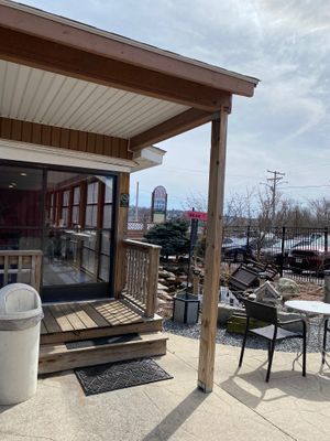 Outdoor seating area with a view of the screened in porch seating.  at The Pink Bean in Somerset