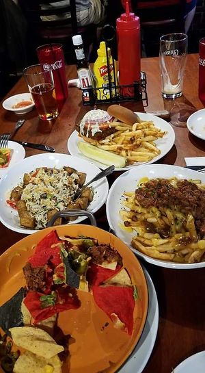 Poutine, burger, nachos & rice dish at Three Dollar Deweys in Portland