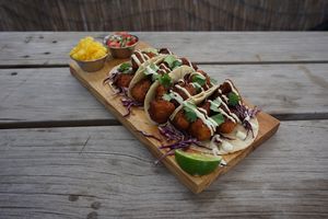 Crispy chipotle cauliflower tacos with cabbage, pickled onions and avocado sour-cream. Accompanied with pico de gallo, pineapple and jalapeño.  at Once:Once in Antigua