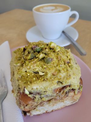 Pistachio cinnamon bun with a cappuccino at Miło bistro in Warsaw