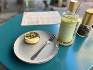 Pistachio cheese cake with iced matcha latte  at LUUC Café in Saarbrucken