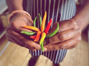 Mix of colourful chillis held by staff at Lungi Babas. at Lungi Babas in Frome