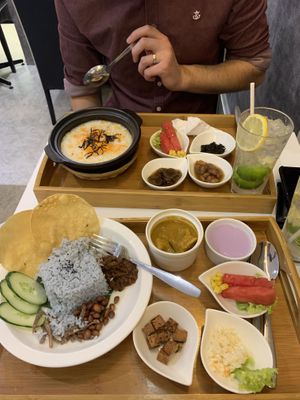 Nasi lemak and a porridge dish at Minf Houze Vegan Cafe in Kuala Lumpur