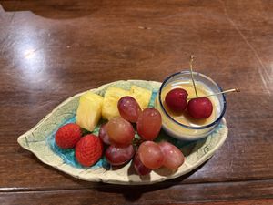 Dessert of rice pudding with maple syrup and fruit   at Acai in Kashihara