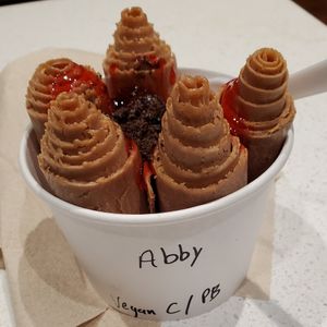 Vegan Chocolate base with peanut butter mix-in, strawberry syrup and oreo topping. at Curl de la Crème in Pigeon Forge