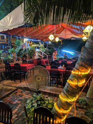 Lovely outdoor seating area by Mekong River at Tamarind Tree Restaurant Mekong in Luang Prabang