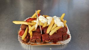 2 vegan currywurst with fries, ketchup, curry powder, and vegan mayo. at Curry 61 in Berlin