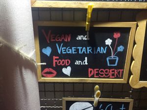 Sign outside the bar at Roots Experience in Lisbon