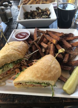 Tempeh Banh Mi sandwich with sweet potato fries.  I recommend the sandwich, but not the fries.  Really, don't get them.  Over cooked and over salted.  Have a side salad instead. at Thirsty Barrel Taphouse & Grille in Grass Valley
