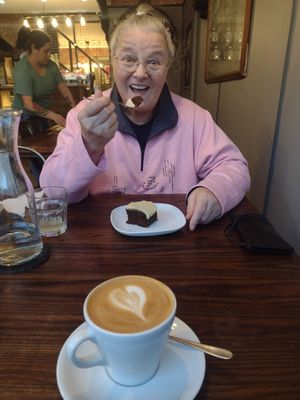 Lovely friend tucks into vegan gingerbread cake & oatmylk latte. at Rialto in Eyemouth