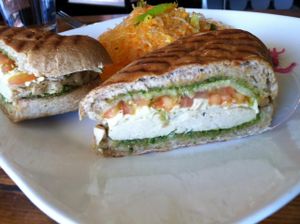 Chicken pesto sandwich with kelp salad, side view. at Golden Mean in Santa Monica