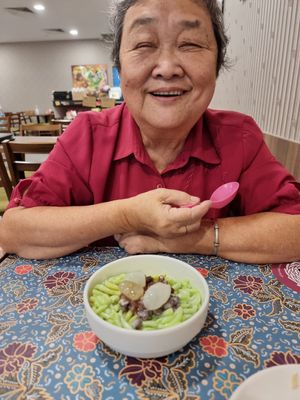 A happy mom with bowl of cendol with attap seeds at Warung Ijo in Central Singapore