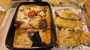 Vegan lasagna with garlic bread   at Celeiro Cafe in Peniche