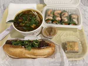 Food tray - banh mi, spicy noodle soup, fresh roll, baklava   at Loving Hut in San Jose