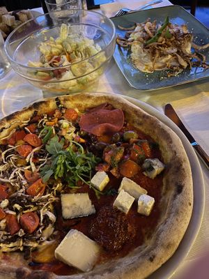 Pizza in front, mixed salad and the culurgiones on the rightt  at Rocca Ja in Castelsardo