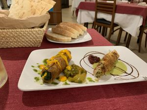 Rolled Sardinian flatbread with sauteed greens and rolled pasta filled with vegetables.  at Il Portico in Nuoro