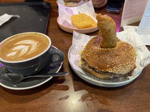 Soy flat white, hash brown and vegan burger with sesame seed bagel   at Balls and Bangles in Queenstown