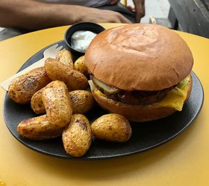 Vegan Cheeseburger with side of baked potatoes   at Not Dog in Nice